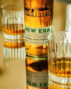 Close Up of a New Era Whisky Bottle and two glasses with whisky in